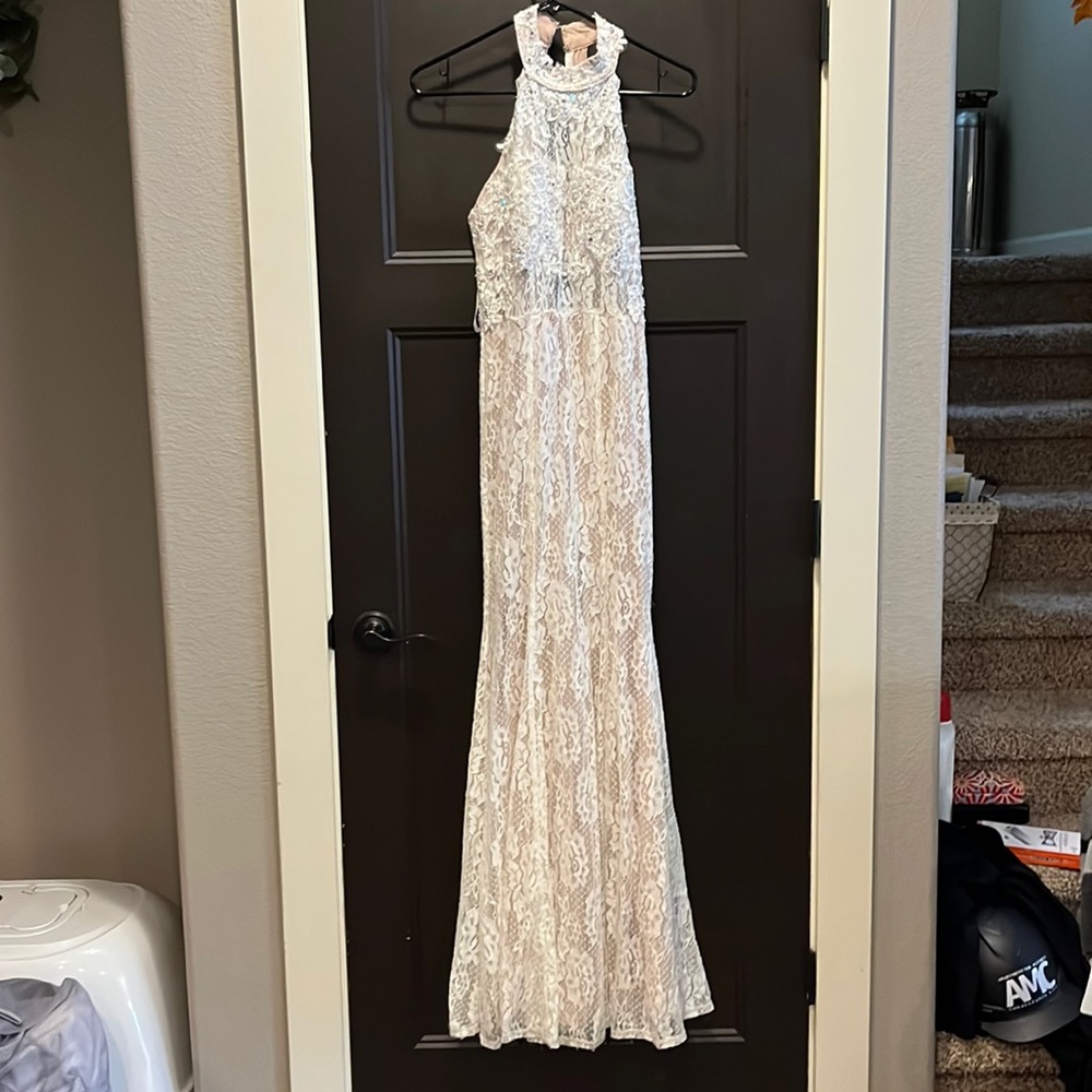 White and beige floor length wedding reception dress.